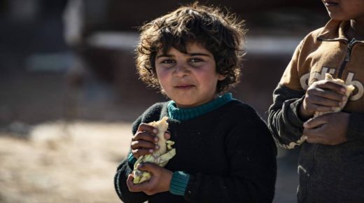 Children eat sandwiches inside the Kurdish-run al-Hol camp for the displaced in the al-Hasakeh governorate in northeastern Syria on January 14, 2020, at the section reserved for Iraqis and Syrians. - Particularly difficult living conditions in the camp reportedly resulted in the death of more than 517 people, including 371 children in 2019. Foreign women and children affiliated with the Islamic State(IS) were mainly sent to al-Hol when they were evacuated from the last stronghold of the jihadist group, reconquered by the Kurdish forces in March 2019. (Photo by DELIL SOULEIMAN / AFP)