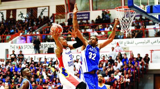 Action between Mighty sports Philippines (white) vs American university Dubai (blue) during 30th Dubai International basketball tournament at Shabab Al Ahli club in Dubai. February 1, 2019. Photo by Patrick Castillo