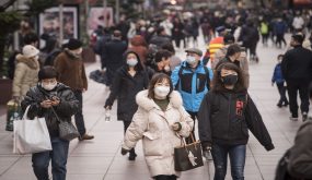 Pedestrians wearing masks walk on Nanjing East Road, a shopping street, in Shanghai , China on Thursday 23 January 2020.