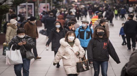 Pedestrians wearing masks walk on Nanjing East Road, a shopping street, in Shanghai , China on Thursday 23 January 2020.