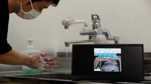 Fujitsu senior researcher Genta Suzuki washes his hands as he demonstrates AI-camera recognition technology that checks whether people follow six handwashing steps recommended by the Japanese health ministry during an interview with Reuters at the company's research and development laboratory in Kawasaki, Japan June 17, 2020. Picture taken June 17, 2020. REUTERS/Kim Kyung-Hoon