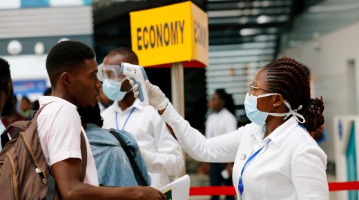 FILE PHOTO: A health worker checks the temperature of a traveller as part of the coronavirus screening procedure at the Kotoka International Airport in Accra, Ghana January 30, 2020. REUTERS/Francis Kokoroko/File Photo - RC2EUE9X5YKK