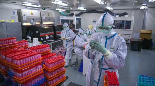This photo taken on November 23, 2020 shows technicians processing Covid-19 coronavirus tests at a laboratory in Tianjin, China. (Photo by STR / CNS / AFP) / China OUT