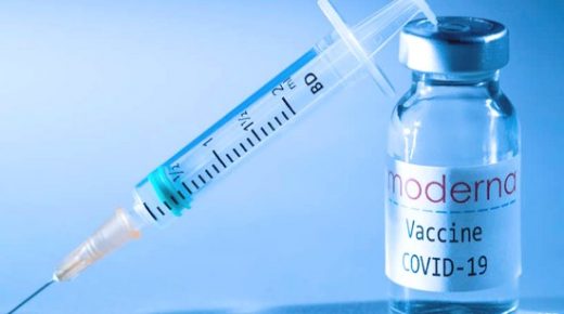 This illustration picture taken in a studio in Paris on November 16, 2020, shows a syringe and a vial with the logo of US biotech firm Moderna. - Moderna on November 16, 2020 announced its experimental vaccine against Covid-19 was almost 95 percent effective, marking a second major breakthrough in the quest to end the pandemic. (Photo by JOEL SAGET / AFP)