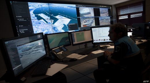 A member of the port police watches a screen in the control center at the Algeciras port on July 30, 2017.. Thousands of Moroccan nationals working and living in Europe pass through the Strait of Gibraltar as they return to spend vacations in Morocco. / AFP PHOTO / JORGE GUERRERO