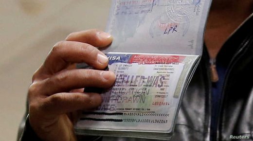 FILE PHOTO: A member of the Al Murisi family, Yemeni nationals who were denied entry into the U.S. because of the travel ban, shows the cancelled visa in their passport from their failed entry to reporters as they successfully arrive to be reunited with their family at Washington Dulles International Airport in Chantilly, Virginia, U.S., February 6, 2017. REUTERS/Jonathan Ernst/Files