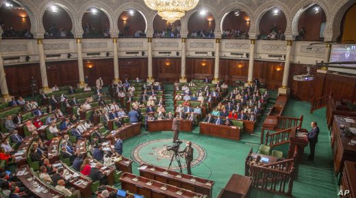Tunisian designated Prime Minister Hichem Mechichi, right, delivers his speech at the parliament before a confidence vote in Tunis, Tuesday, Sept. 1, 2020. (AP Photo/Riadh Dridi)