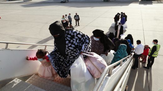 Migrants board a flight in Misrata, Libya, Wednesday, Nov. 2, 2021. The Libyan authorities, in cooperation with the International Organization for Migration (IOM), repatriated 91 Nigerien migrants, most of them children, from the city of Misrata, on Wednesday, as part of the program to resume voluntary flights to deport migrants from the country. (AP Photo/Yousef Murad)