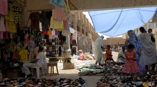 Local people look for goods at a market place in the city of Nouakchott, Mauritania, on Friday, Aug. 8, 2008. Envoys from the African Union and the Arab League are scheduled to visit Mauritania on Friday to meet with coup leaders who seized control three days earlier. The general who masterminded Africa's latest coup, Mohamed Ould Abdel Aziz, has promised to hold elections and set up an 11-member "state council" to rule until then.(AP Photo/Candace Feit)