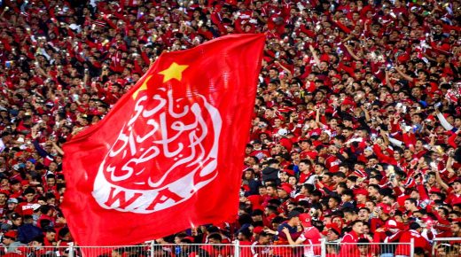Supporters hold a giant Wydad's flag as they attend the CAF Champions league's match between Wydad Casablanca and Zamalek at the Mohammed V Stadium, in Casablanca, on February 26, 2022, after the reopening of the football fields in Morocco. (Photo by AFP) (Photo by -/AFP via Getty Images)