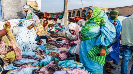 Women look at "melhafa", traditional pieces of clothes, in the capital's market after a storm on April 2, 2019 in Nouakchott. (Photo by Carmen Abd Ali / AFP)