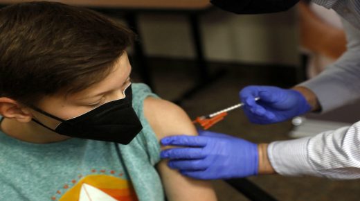 Aiden Arthurs receives the Pfizer-BioNTech COVID-19 Vaccine by Andrew Mac (R) at the Jewish Federation/JARCÕs offices in Bloomfield Hills, Michigan on May 13, 2021.