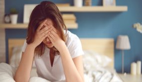Unhappy girl in a bedroom