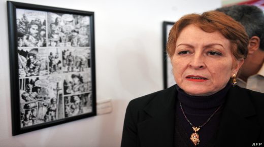 Algerian culture minister khalida Toumi stands next to comics picture at the exhibition held on the eve of the 3rd International Comics Festival at the Esplanade of Ryad El Feth, on October 13, 2010 in Algiers. The third International Comics Festival of Algiers (FIBDA) will be held from 13 to 17 October with the participation of a hundred cartoonists from about forty countries. AFP PHOTO/FAYEZ NURELDINE (Photo by FAYEZ NURELDINE / AFP)