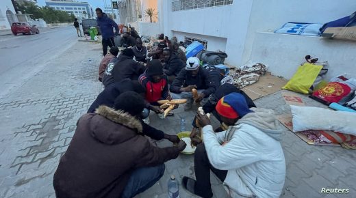 African refugees and asylum seekers break their fast during the holy fasting month of Ramadan, as they gather during an open-ended sit-in asking for evacuation from Tunisia, outside the headquarters of United Nations High Commissioner for Refugees (UNHCR), in Tunis, Tunisia April 20, 2022. Picture taken April 20, 2022. REUTERS/Jihed Abidellaoui