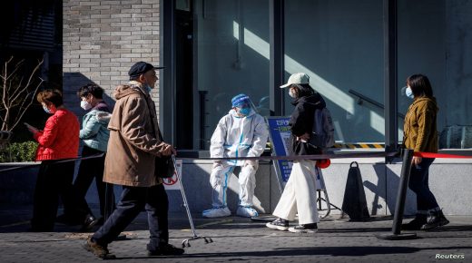 FILE PHOTO: A health worker wears a protective suit near a testing booth as outbreaks of coronavirus disease (COVID-19) continue in Beijing, China, Oct. 23, 2022. REUTERS/Thomas Peter/File Photo