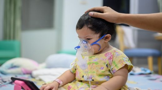 Asian baby was sick as Respiratory Syncytial Virus (RSV) in kid hospital. Thai little girl having inhaler containing medicine for stop coughing and disease flu.