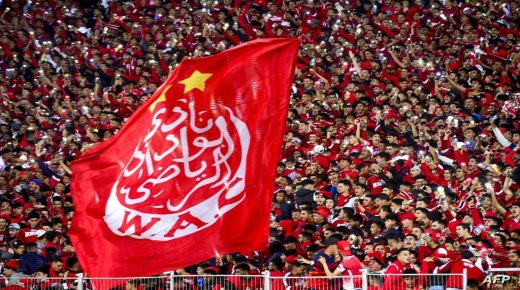 Supporters hold a giant Wydad's flag as they attend the CAF Champions league's match between Wydad Casablanca and Zamalek at the Mohammed V Stadium, in Casablanca, on February 26, 2022, after the reopening of the football fields in Morocco. (Photo by AFP)