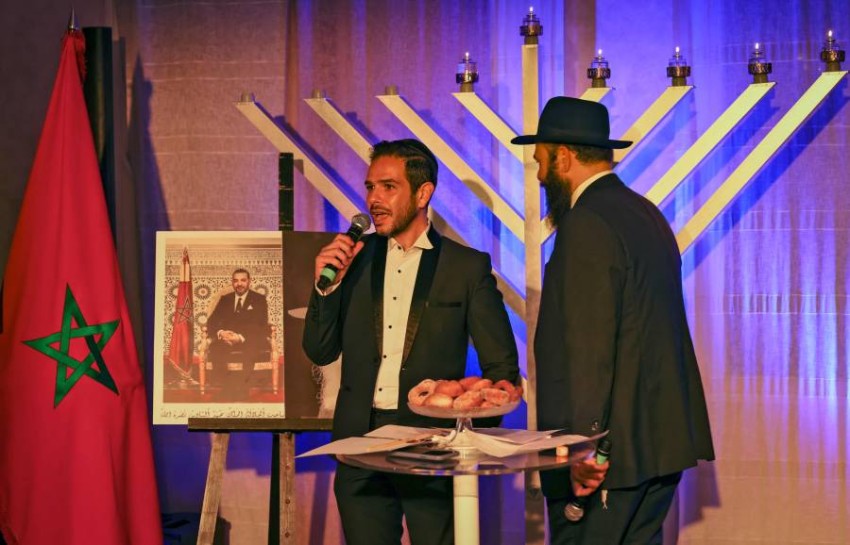 A Moroccan Rabbi and a member of Casablanca's Jewish community are pictured during a ceremony on the fifth night of the Jewish holiday of Hanukkah on December 14, 2020 in Casablanca. (Photo by FADEL SENNA / AFP)