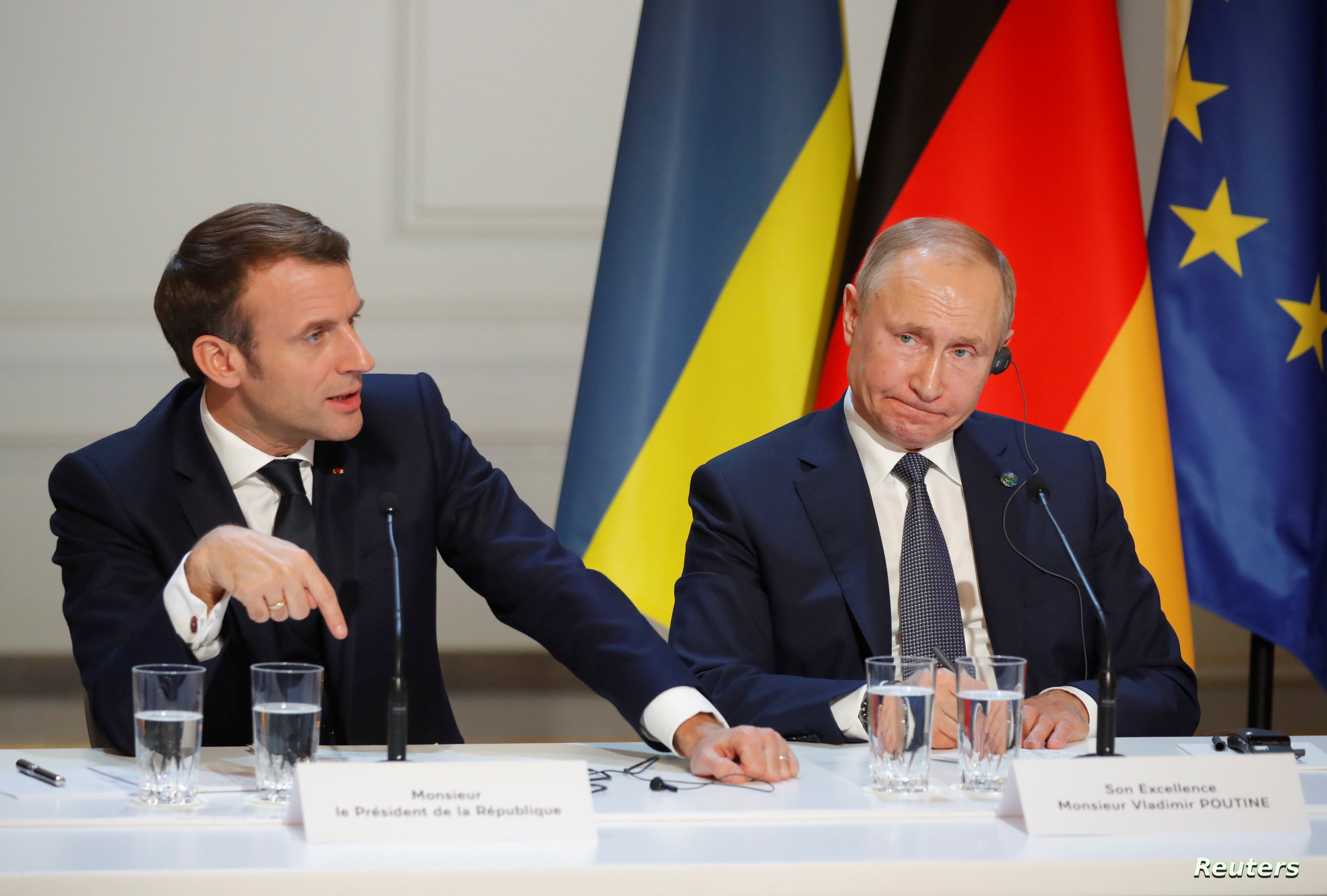 French President Emmanuel Macron and Russia's President Vladimir Putin attend a joint news conference after a Normandy-format summit in Paris, France December 9, 2019. REUTERS/Charles Platiau/Pool