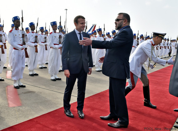 Morocco's King Mohammed VI (R) speaks with French President Emmanuel Macron as they review the honour guard in Rabat, Morocco, June 14, 2017. REUTERS/Alain Jocard/Pool
