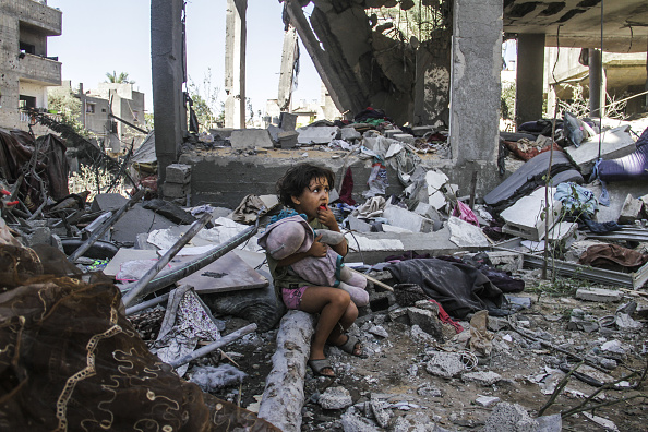 JABALIA, GAZA - SEPTEMBER 11: A child holds a doll among the rubbles of a heavily damaged house as 9 people, including 3 children, were killed in an attack by the Israeli army on the house of Dr. Akram al-Najjar, a lecturer at University of Jerusalem in the Jibaliya Refugee Camp in Jabalia, Gaza on September 11, 2024. (Photo by Mahmoud ssa/Anadolu via Getty Images)