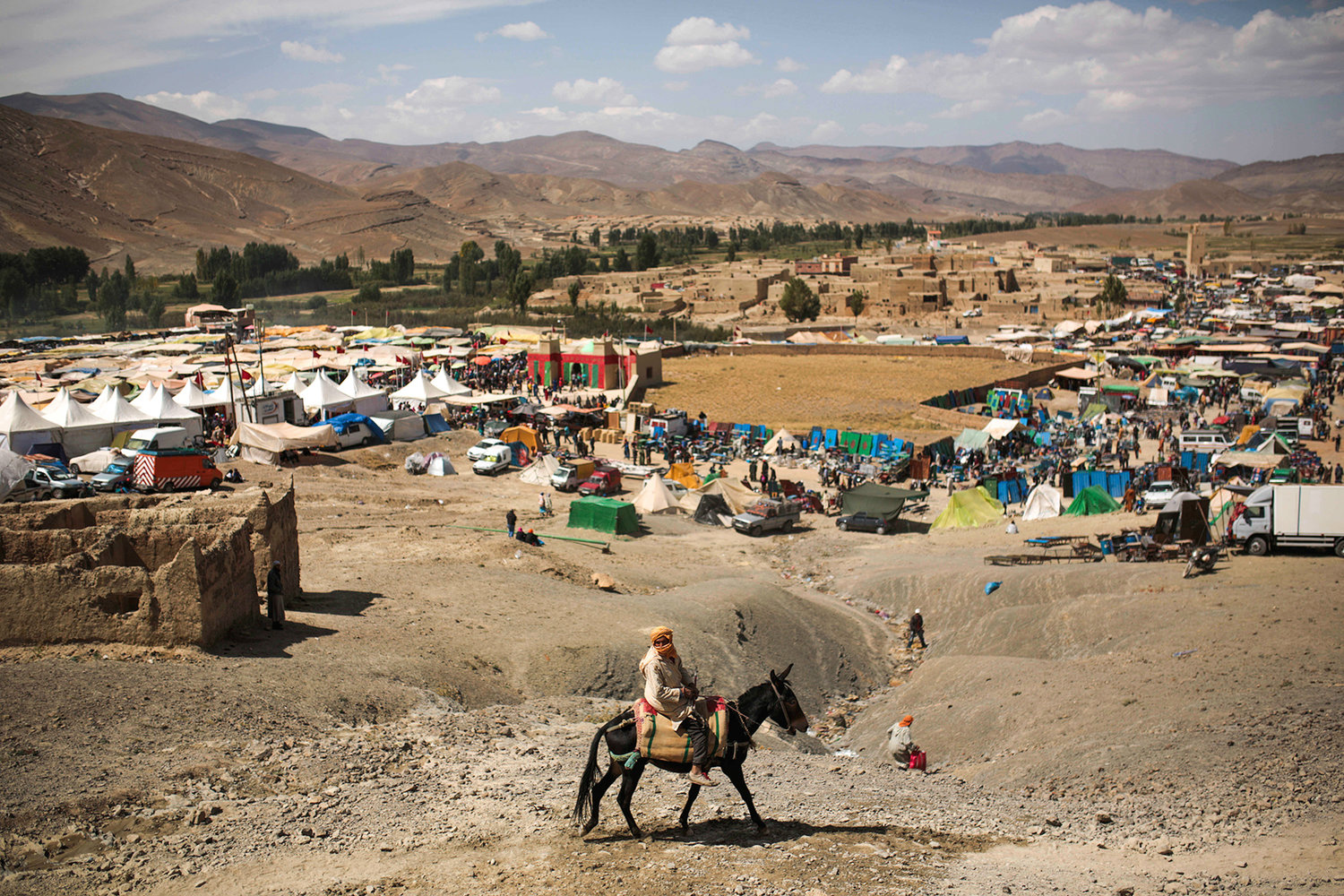 In this Friday, Sept. 22, 2017 photo, a Berber farmer rides his donkey at the annual festival of Imilchil, in Morocco's Atlas mountains. What started as an annual marriage festival has become an economic boon for a tiny Berber village tucked into in the foothills of Morocco's Atlas Mountains. Today, the event is arranged to coincide with a large three-day market that marks the end of the harvest season. (AP Photo/Mosa'ab Elshamy)
